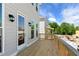 Spacious wooden deck features a railing and access to the home's interior with outdoor lighting at 175 Basil St, Cumming, GA 30040