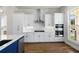 Modern kitchen with white cabinets, stainless appliances, and a center island at 175 Basil St, Cumming, GA 30040