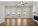 Sunlit living room with hardwood floors, brick fireplace, and doors to the outdoor deck at 175 Basil St, Cumming, GA 30040