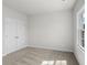 Cozy bedroom with soft carpeting, a large window, and double door closet at 175 Basil St, Cumming, GA 30040