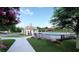 Beautiful pool and pool house with blooming flowers in the foreground and trees in the background at 175 Basil Street St, Cumming, GA 30040