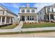 Beautiful two-story brick home featuring a charming front porch and manicured lawn at 175 Basil St, Cumming, GA 30040