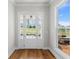 Bright foyer with hardwood floors, a glass-paneled front door, and a clear view of the outdoors at 175 Basil St, Cumming, GA 30040