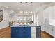 Open-concept kitchen with a large island, stainless steel dishwasher, and hardwood floors at 175 Basil St, Cumming, GA 30040