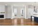 Open concept living room with fireplace and hardwood flooring leading into the kitchen at 175 Basil St, Cumming, GA 30040