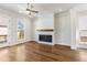 Hardwood floors and fireplace enhance this airy, bright living area at 175 Basil St, Cumming, GA 30040