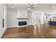 Spacious living room with a white brick fireplace, ceiling fan, and hardwood floors at 175 Basil Street St, Cumming, GA 30040