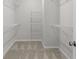 Walk-in closet with wire shelving, carpeted floor, and ample storage space at 175 Basil St, Cumming, GA 30040