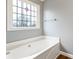 Modern bathtub with stained glass window at 3165 Pucketts Mill Rd, Buford, GA 30519