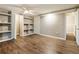 Finished basement bedroom featuring hardwood floors, large built in shelving, and a neutral paint palette at 3165 Pucketts Mill Rd, Buford, GA 30519