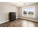 Bedroom featuring a hardwood floor, dresser and view at 3165 Pucketts Mill Rd, Buford, GA 30519
