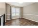 Cozy bedroom with neutral walls, hardwood floors, and a large window with curtains at 3165 Pucketts Mill Rd, Buford, GA 30519
