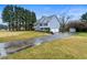 View of the home's exterior highlighting the driveway, garage, and well-maintained landscaping at 3165 Pucketts Mill Rd, Buford, GA 30519