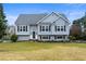 Charming two-story home featuring a well-manicured lawn and traditional architectural details at 3165 Pucketts Mill Rd, Buford, GA 30519