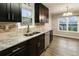 Modern kitchen featuring dark cabinets, granite countertops, stainless steel appliances, and hardwood floors at 3165 Pucketts Mill Rd, Buford, GA 30519