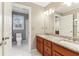 Bathroom featuring a double sink vanity with granite countertop and white tile floors at 3468 Pine Grove Dr, Douglasville, GA 30135