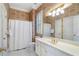 Bathroom with vanity, toilet, shower with curtain, and shuttered window at 4610 Wynmeade Ne Park, Marietta, GA 30067