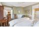 Inviting bedroom with olive walls and views to the living room and en suite bath at 4610 Wynmeade Ne Park, Marietta, GA 30067