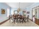Stylish dining room with wainscoting, chandelier, and seating for eight at 4610 Wynmeade Ne Park, Marietta, GA 30067