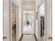 Hallway with view of closets and adjacent bathroom featuring floral wallpaper and white tile flooring at 4610 Wynmeade Ne Park, Marietta, GA 30067
