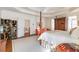Large main bedroom with four-poster bed, sitting area, and unique decor at 4610 Wynmeade Ne Park, Marietta, GA 30067