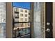 Balcony view with open blinds of community pool and building architecture at 5300 Peachtree Rd # 1311, Atlanta, GA 30341