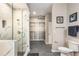 Bathroom featuring a glass-enclosed shower, a walk-in closet, tile floors, and modern fixtures at 5300 Peachtree Rd # 1311, Atlanta, GA 30341
