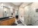 Bathroom featuring a glass-enclosed shower, a soaking tub, vanity with wooden cabinets, and an ensuite at 5300 Peachtree Rd # 1311, Atlanta, GA 30341