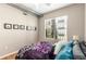 Comfortable bedroom with a large window, ceiling fan, and unique ductwork, complemented by framed wall art at 5300 Peachtree Rd # 1311, Atlanta, GA 30341
