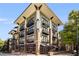 Modern apartment building featuring stylish architecture, multiple balconies, and street-level commercial spaces at 5300 Peachtree Rd # 1311, Atlanta, GA 30341