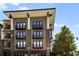 Modern apartment building featuring balconies, brick accents, and street-level retail space at 5300 Peachtree Rd # 1311, Atlanta, GA 30341