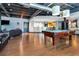 Spacious game room features a pool table, kitchen area, exposed ductwork, hardwood flooring, and comfortable seating at 5300 Peachtree Rd # 1311, Atlanta, GA 30341