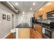 Modern kitchen featuring stainless appliances, wooden cabinets, kitchen island, and hardwood floors at 5300 Peachtree Rd # 1311, Atlanta, GA 30341