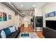 Living room featuring hardwood floors, modern furniture, kitchen, and stainless steel appliances at 5300 Peachtree Rd # 1311, Atlanta, GA 30341