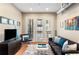Inviting living room featuring a plush rug, stylish seating, and french doors providing access to a balcony at 5300 Peachtree Rd # 1311, Atlanta, GA 30341