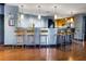Lounge bar seating area featuring kitchen in the background and wooden floors at 5300 Peachtree Rd # 1311, Atlanta, GA 30341