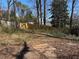 Backyard with sparse foliage and a wood fence in the distance behind the property at 542 Sugar Hill Nw Dr, Marietta, GA 30060