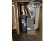 Mechanical basement view of water heater and HVAC unit requiring updates at 542 Sugar Hill Nw Dr, Marietta, GA 30060