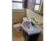 Bathroom features a dark vanity, white sink, toilet, and yellow tile with dark accents at 542 Sugar Hill Nw Dr, Marietta, GA 30060