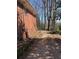 Back corner of a brick building with a sidewalk running along side it surrounded by trees at 542 Sugar Hill Nw Dr, Marietta, GA 30060