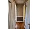 Hallway with dark wood floors, brown and white walls, and white trim with multiple doorways at 542 Sugar Hill Nw Dr, Marietta, GA 30060