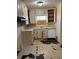 Outdated kitchen featuring white cabinets and peeling flooring, offering a blank canvas for renovation at 542 Sugar Hill Nw Dr, Marietta, GA 30060