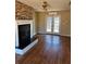 The living room showcases hardwood floors, a stone fireplace, and French doors to the backyard at 542 Sugar Hill Nw Dr, Marietta, GA 30060