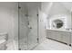 Modern bathroom featuring a glass enclosed shower, marble floors, and a vanity with backlit mirror at 225 Dovecrest Dr, Atlanta, GA 30305
