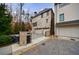 Elegant home exterior with a three-car garage, beautiful brick facade, and well-maintained landscaping at 225 Dovecrest Dr, Atlanta, GA 30305