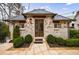 Charming brick pool house with symmetrical landscaping, stone path and string lights at 225 Dovecrest Dr, Atlanta, GA 30305