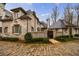 Beautiful brick home with manicured landscaping, a charming entrance gate, and a cobblestone street at 225 Dovecrest Dr, Atlanta, GA 30305