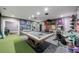 Spacious home gym with a billiard table, exercise equipment, and motivational sports decor at 225 Dovecrest Dr, Atlanta, GA 30305