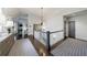 Elegant upstairs hallway with hardwood floors, decorative lighting, and views into adjacent rooms at 225 Dovecrest Dr, Atlanta, GA 30305