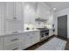 Updated kitchen with white cabinets, stainless steel appliances, and a blue patterned rug at 225 Dovecrest Dr, Atlanta, GA 30305